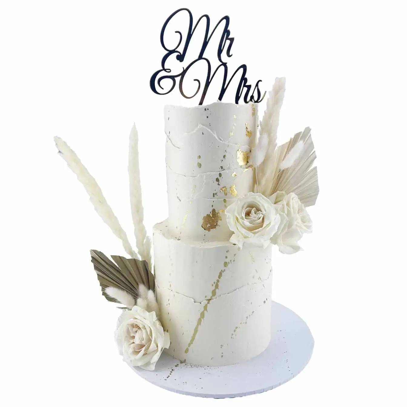 Rustic Wedding Splatter Cake - A two-tier white iced cake with gold splatter, adorned with a mix of fresh and dried flowers, and featuring a 'Mr and Mrs' topper, a stunning centerpiece for your special day.