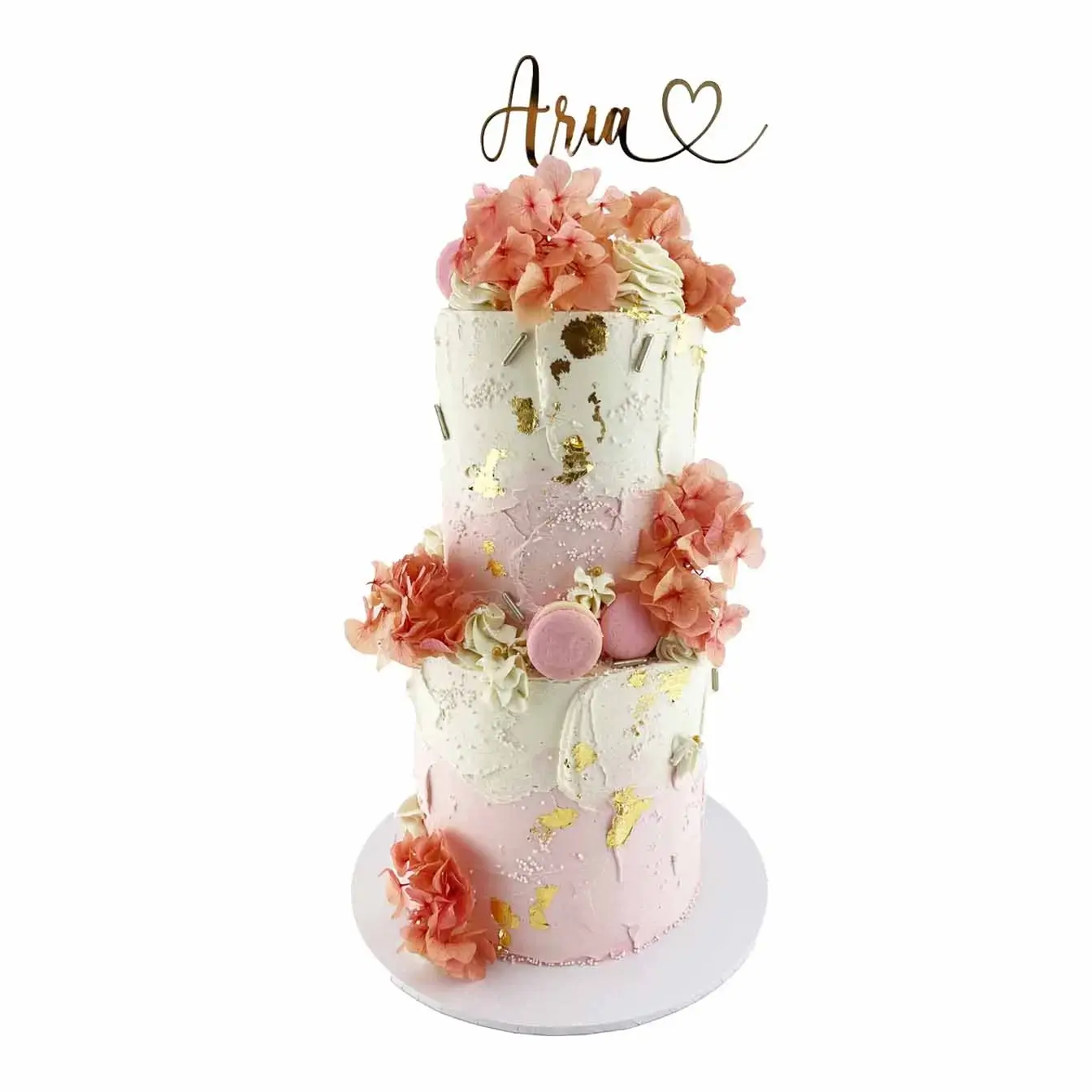 Beautiful pink and white watercolour cake with textured ganache frosting and delicate floral decorations
