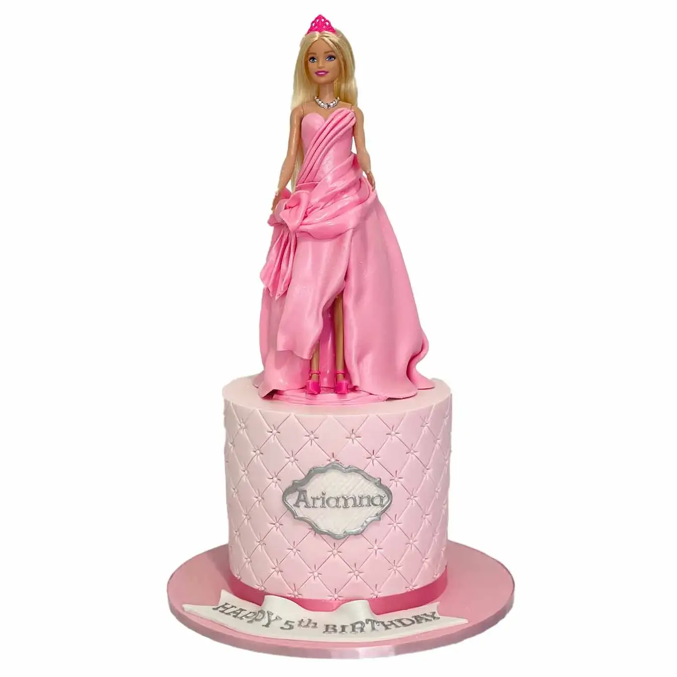 Barbie Dream Princess Cake - A cake with a pink quilted base tier and a Barbie doll wearing a fondant dress, an enchanting centerpiece for celebrations filled with imagination and dreams.