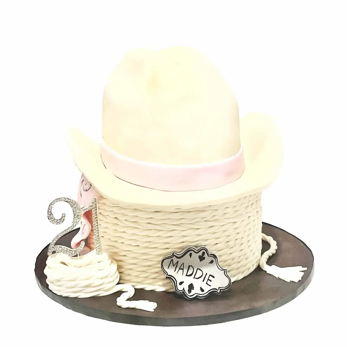 Cowgirl Elegance Cake - A cake with a bottom tier tied with rope and a cowgirl hat on top, a charming centerpiece for celebrations with a touch of western flair.