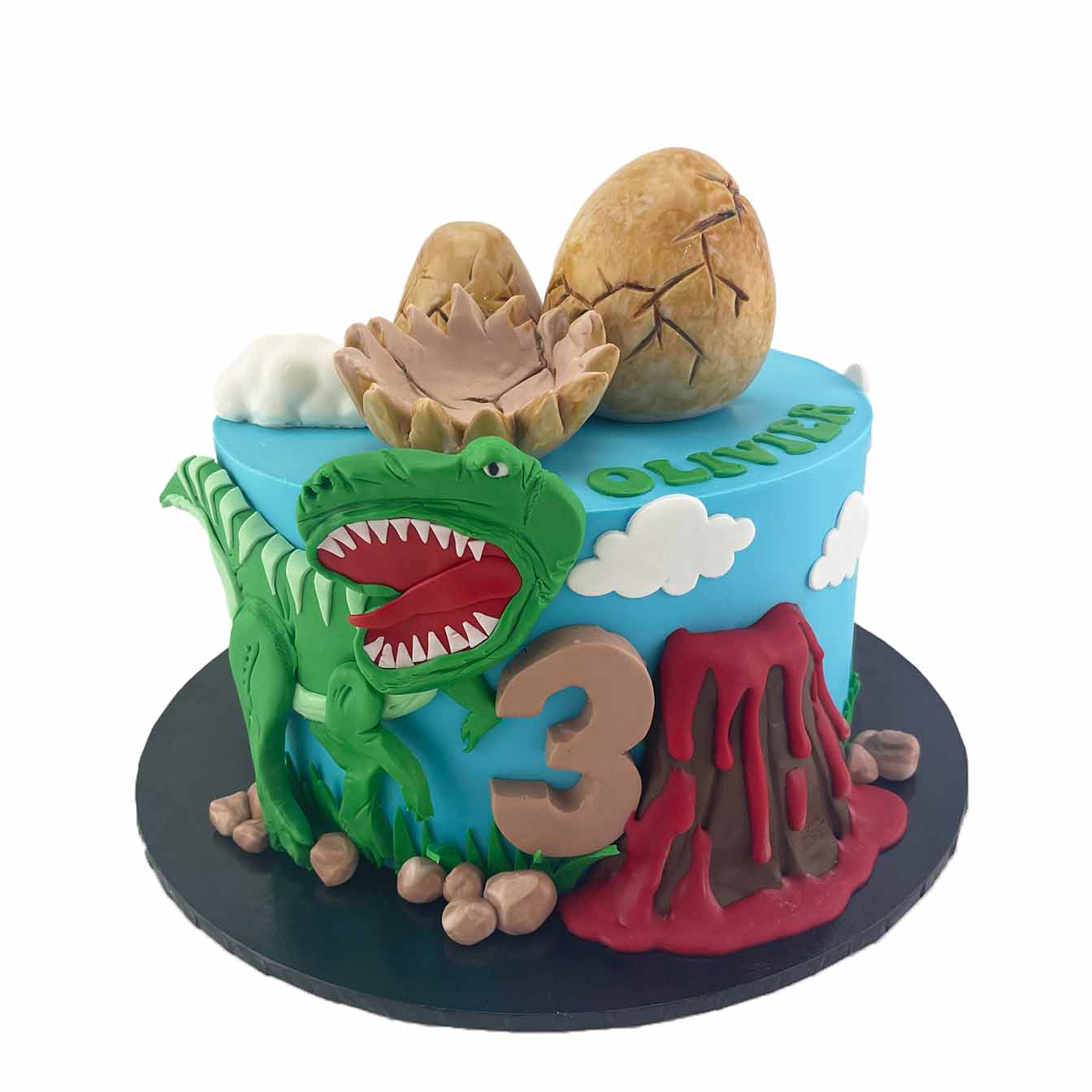Dino Adventure Cake - A blue fondant iced cake with a volcano, 2D dinosaur cutout, and dinosaur eggs, a thrilling centerpiece for dinosaur enthusiasts and birthday celebrations.