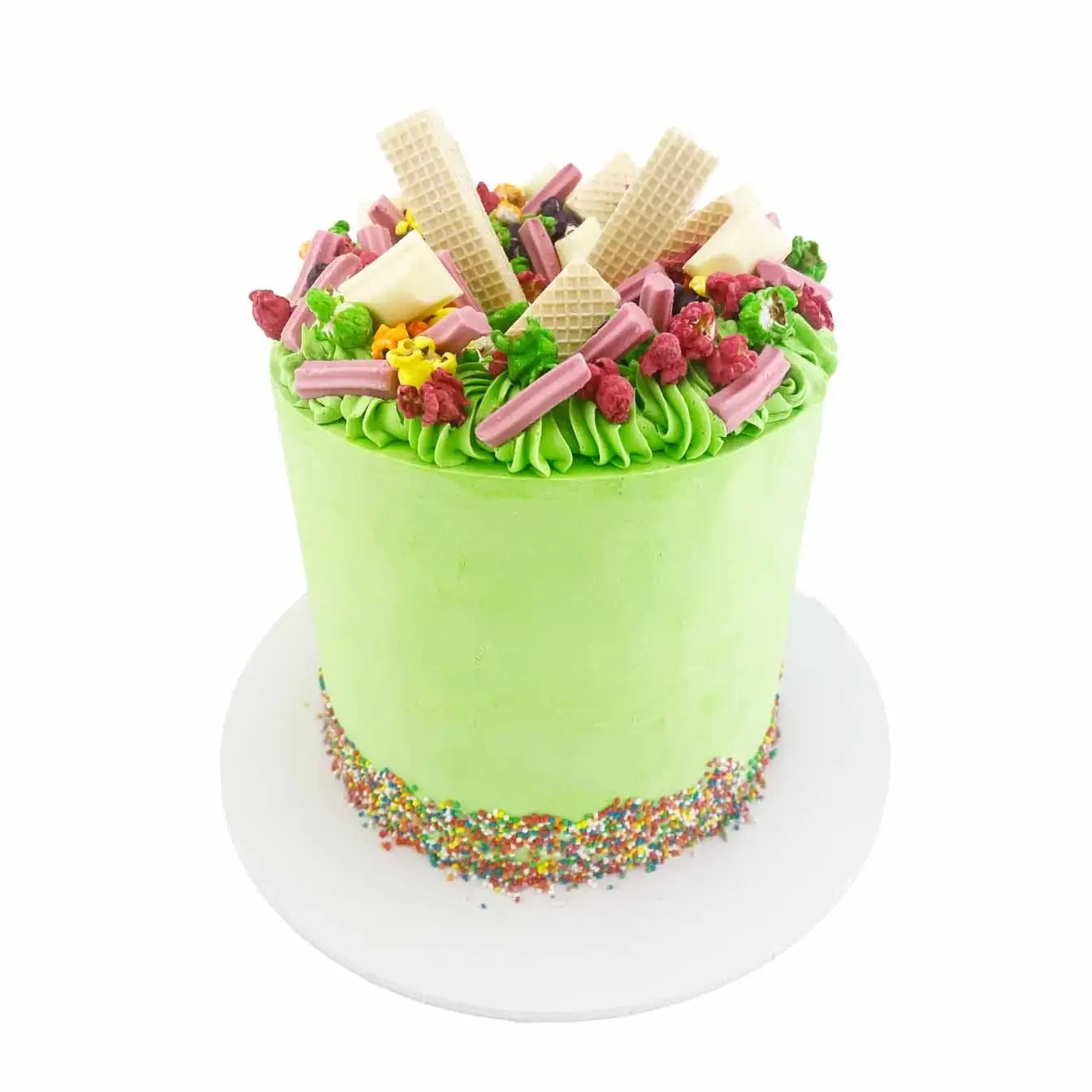 Rainbow popcorn cake with layers of colourful popcorn, musk sticks, vanilla wafers, and white chocolate, topped with whipped ganache and more white chocolate