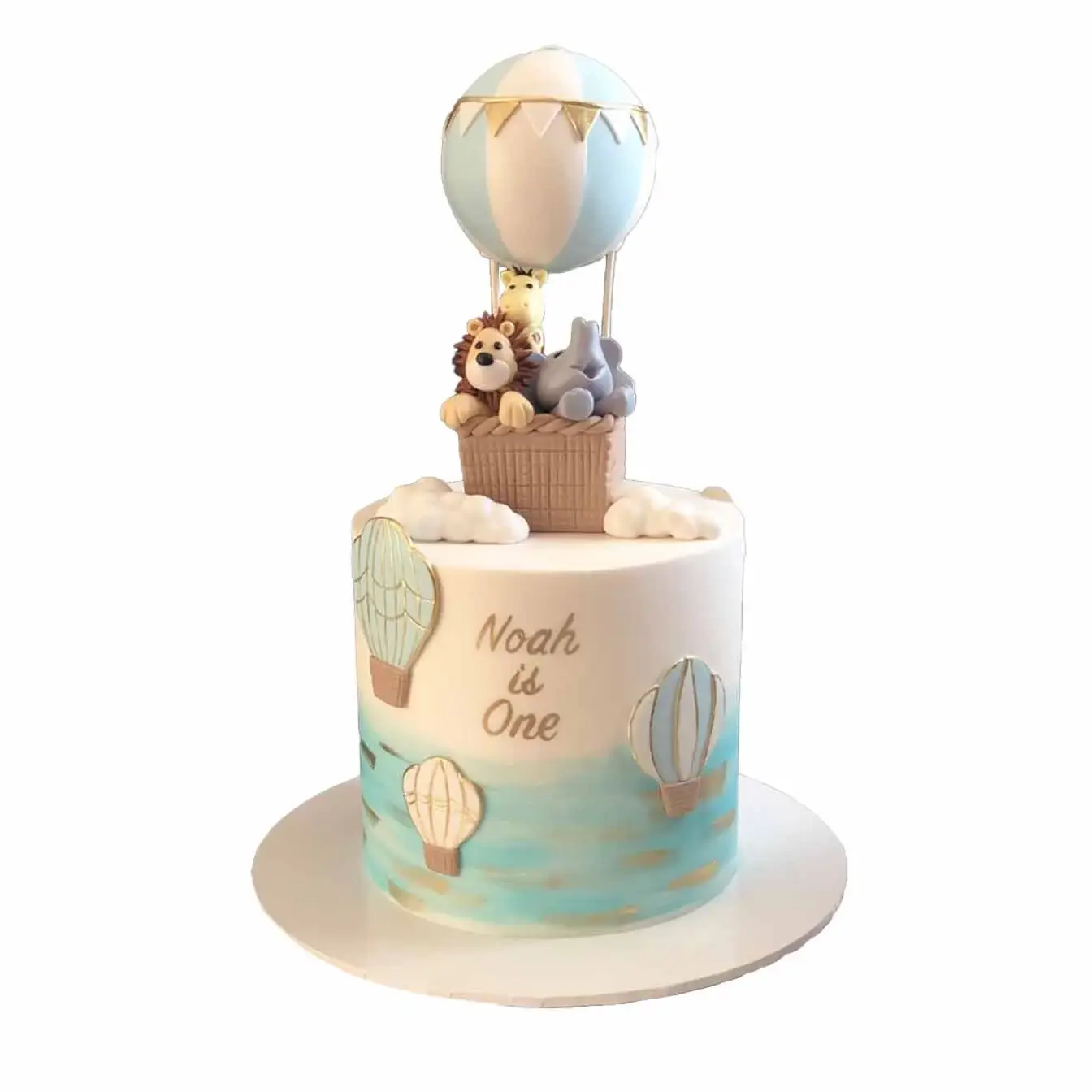 Whimsical Hot Air Balloon Adventure Cake - Double-height fondant-iced cake airbrushed with light blue ombre and adorned with gold accents and cutout hot air balloons, featuring adorable baby animals inside the balloons, an enchanting choice for any celebration.