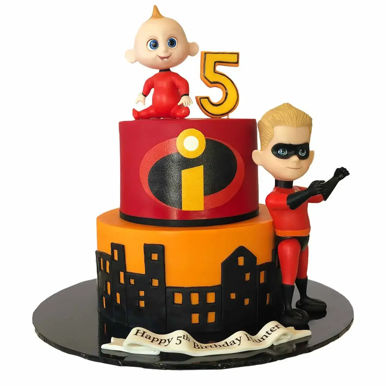 Incredibles Cityscape Cake - A two-tier cake with an Incredibles logo on the red top tier, a black city skyline cutout on the orange bottom tier, and Jack Jack and Dash figurines, a thrilling centerpiece for superhero-themed celebrations.