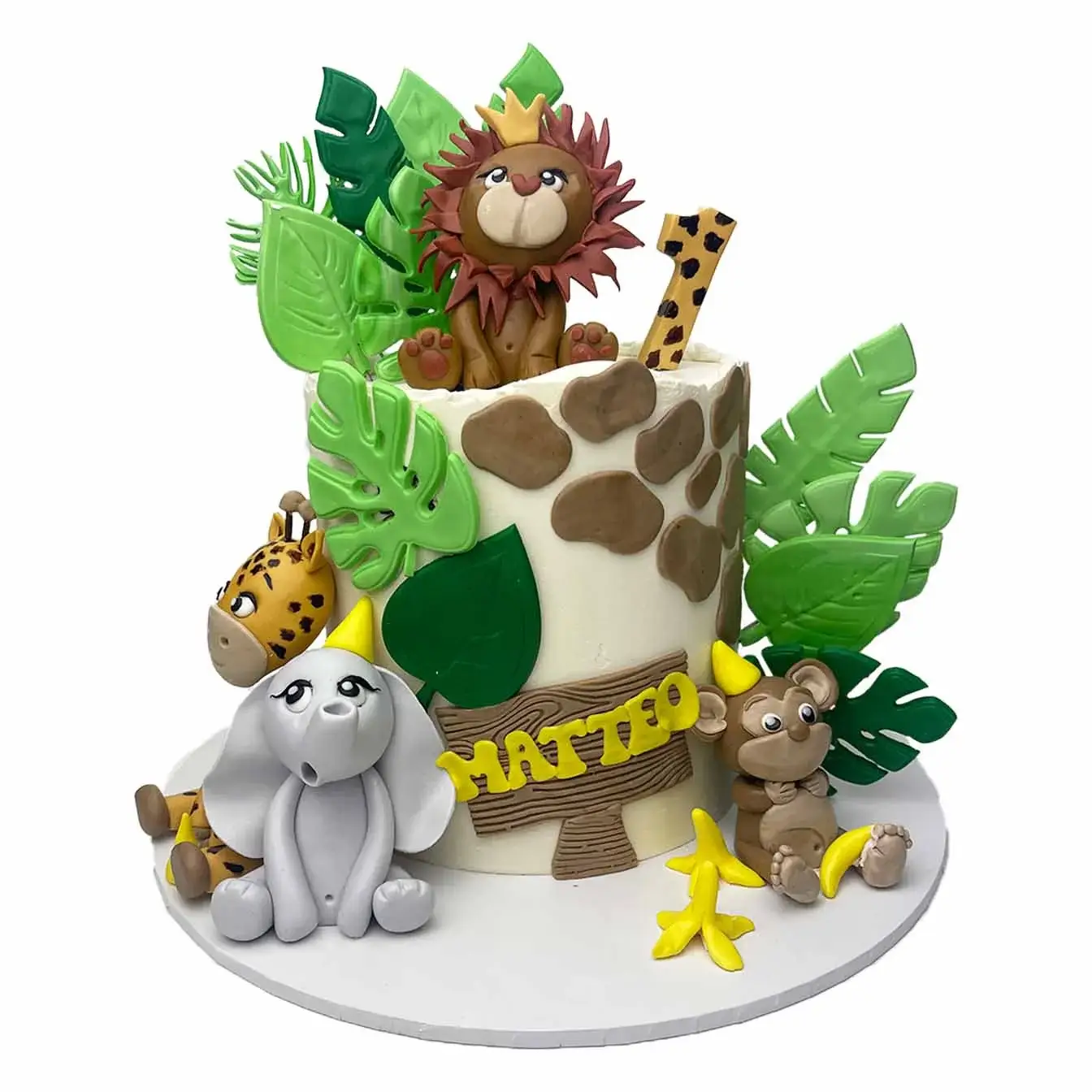 Wild Jungle Adventure Cake - A cake adorned with fondant leaves and edible figures of a monkey, lion, elephant, and giraffe, a whimsical centerpiece for jungle-themed parties and celebrations.