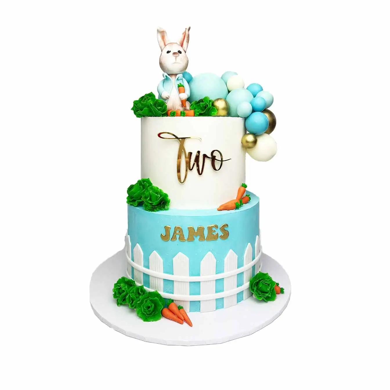 Whimsical Peter Rabbit Garden Cake - A two-tier cake with Peter Rabbit on top, molded carrots, cabbages, and a white picket fence, a flavorful centerpiece for baby showers and birthdays.