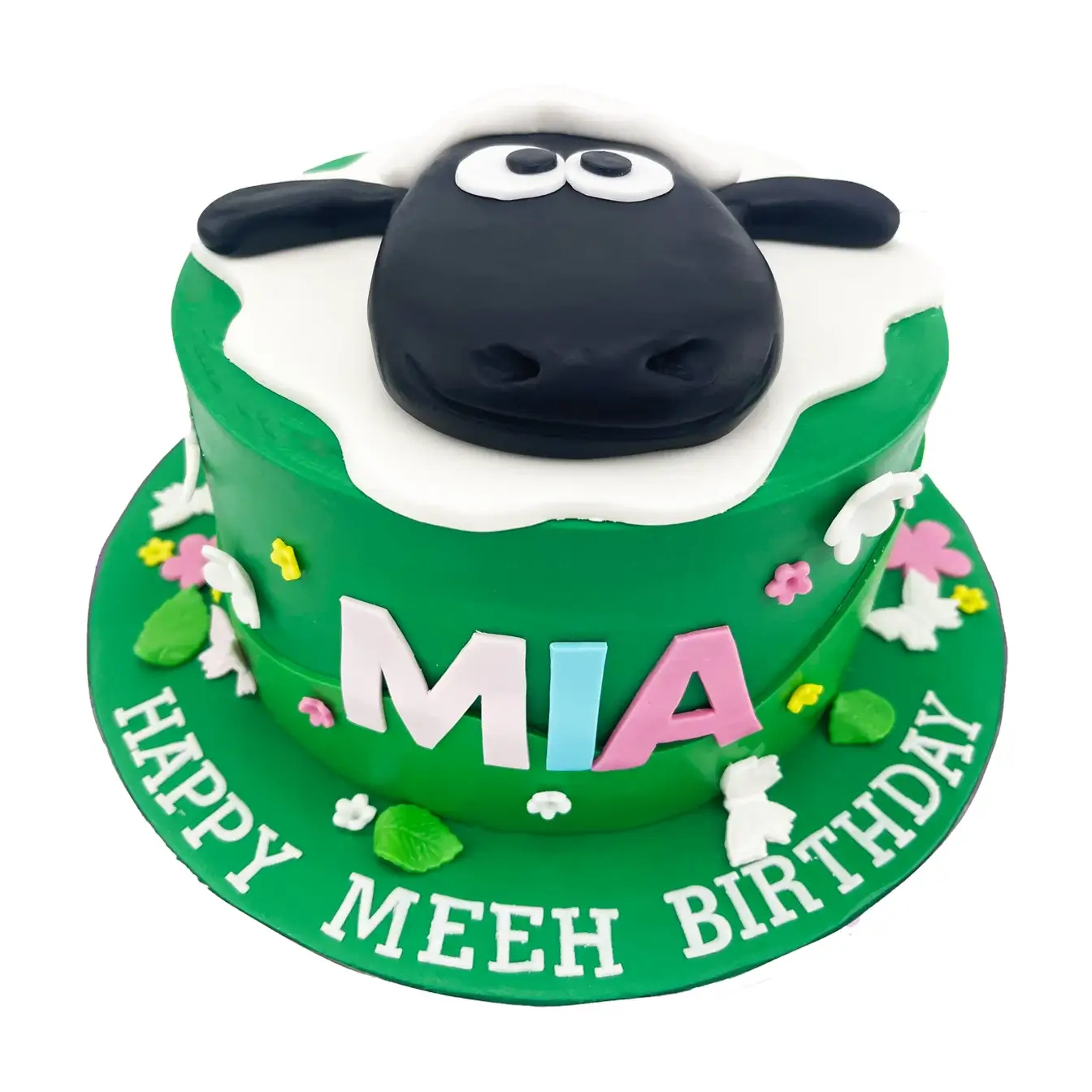 Shaun the Sheep Cake: Green Fondant with Cutout Flowers and Sheep Head Topper