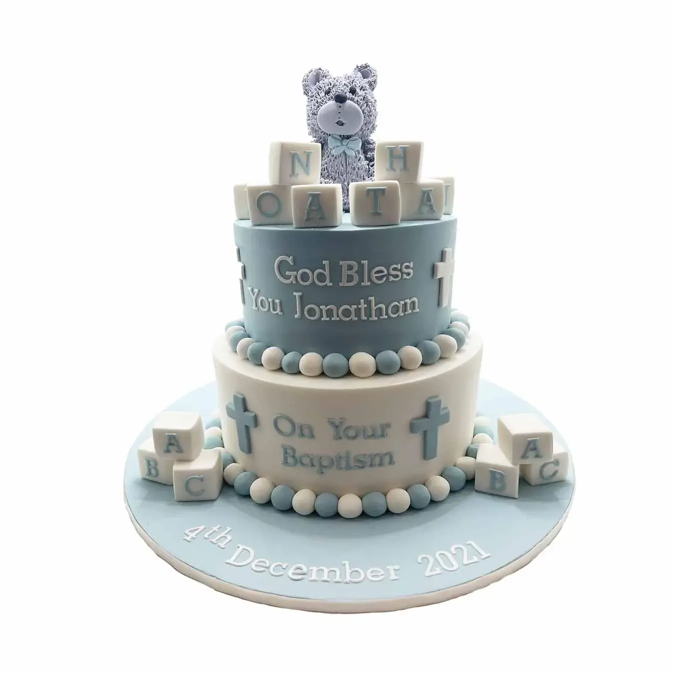 Teddy Bear Blessings Baptism Cake - A two-tier cake adorned with name blocks and a molded teddy bear, a heartfelt centerpiece for baptism and christening celebrations