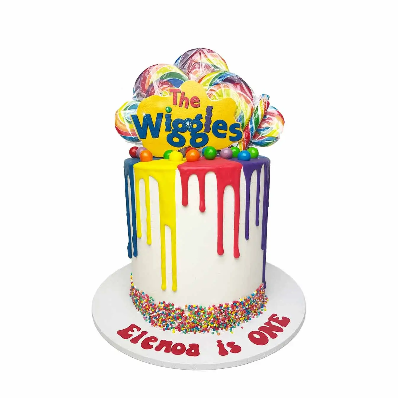 Wiggly Drip Delight Cake - A white base cake with colorful drips, rainbow sprinkles, Wiggles logo, rainbow lollipops, and lollies, a whimsical centerpiece for Wiggles-themed celebrations.